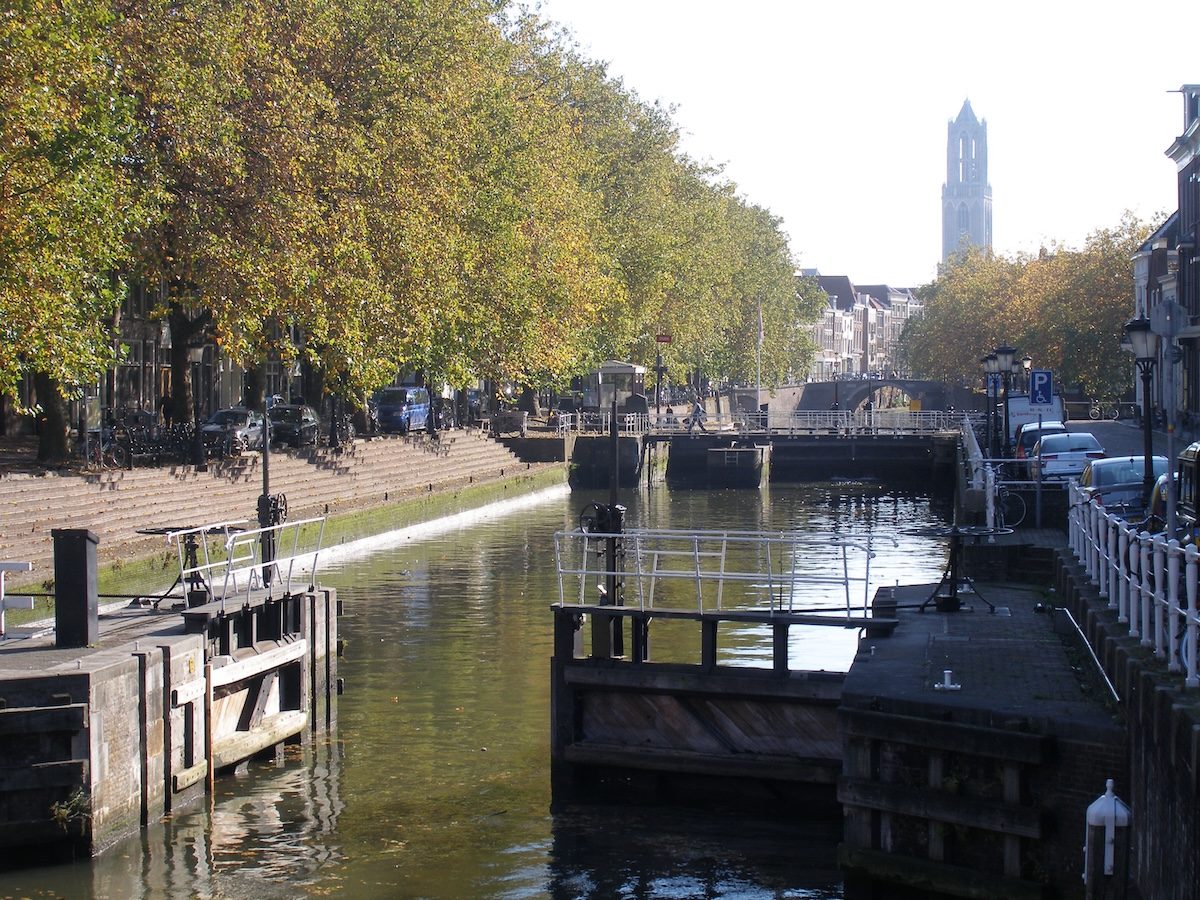 The Weerdsluis lock in Utrecht connecting the Oudegracht to the river Vecht. The Dom tower is in the background.